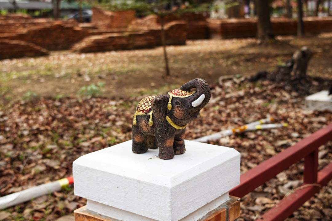 A small elephant statue with its trunk raised
