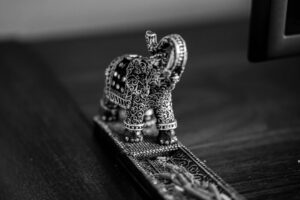Ornate decorated elephant figurine with its trunk raised